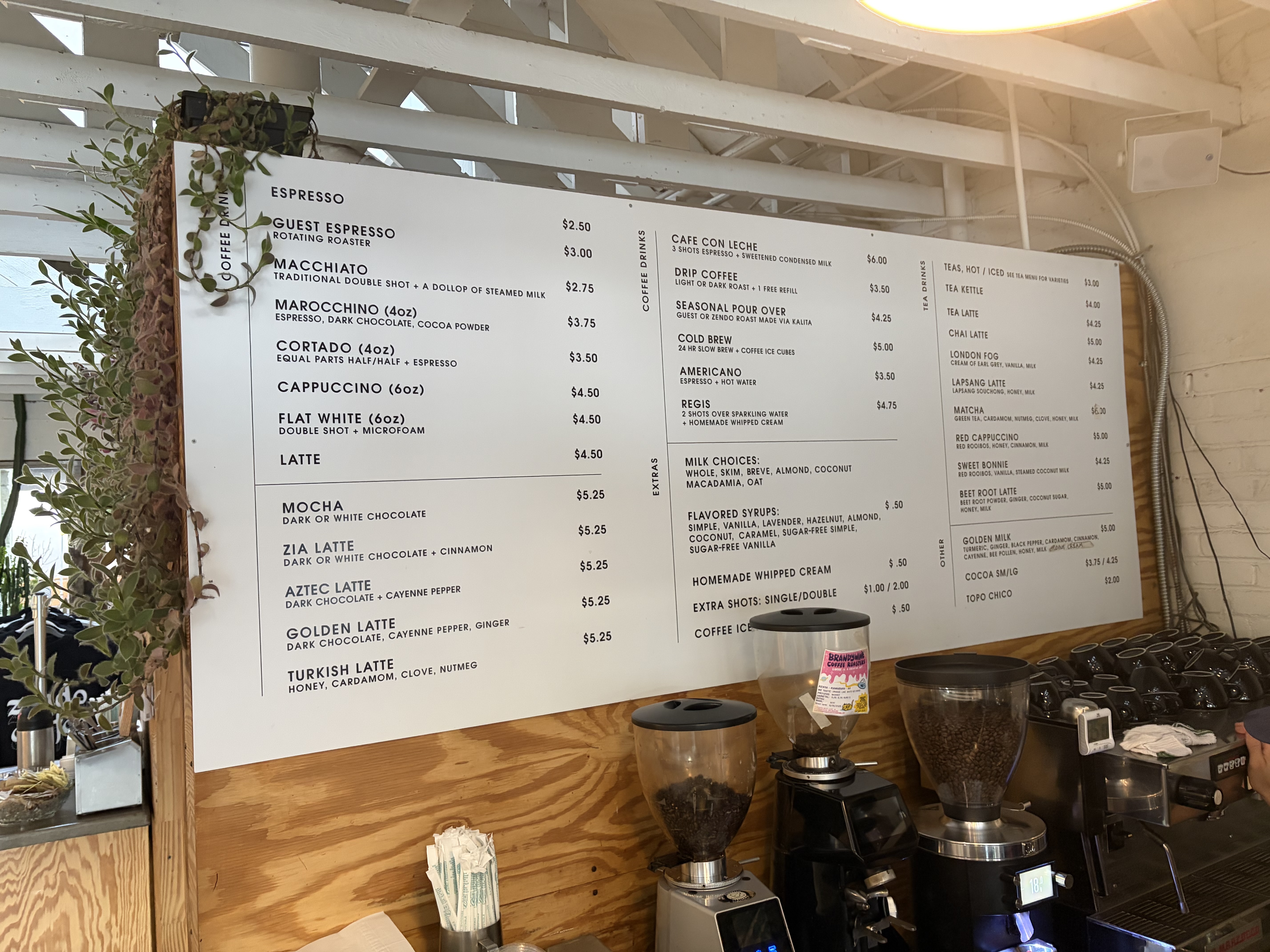 Espresso menu board: guest espresso 2.50, macchiato 3.00, marocchino 2.75, cortado 3.75, cappuccino 3.50, flat white 4.50, latte 4.50, and Zia, Aztec, Golden and Turkish lattes at 5.25.